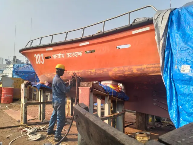 FRP boat undergoing fiber repair and painting