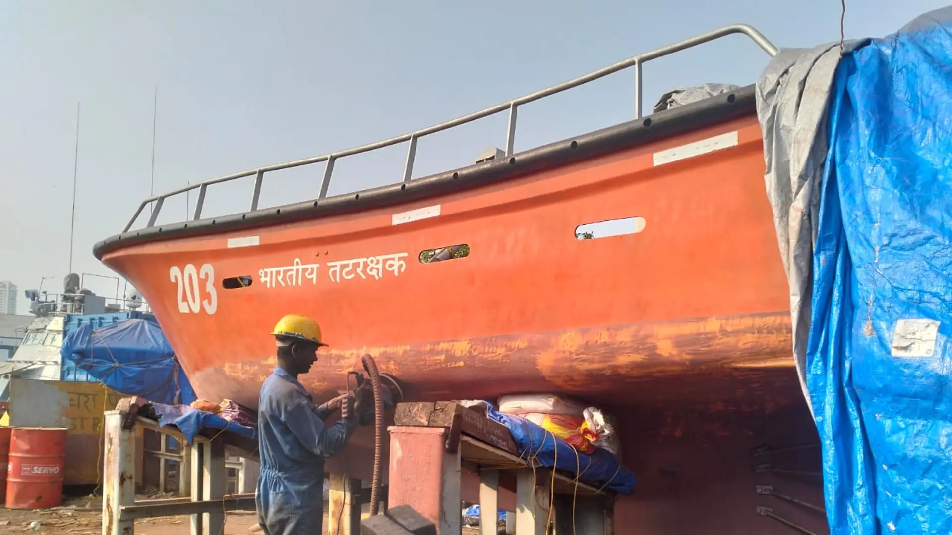 Coast Guard FRP boat under fiber repair at the yard